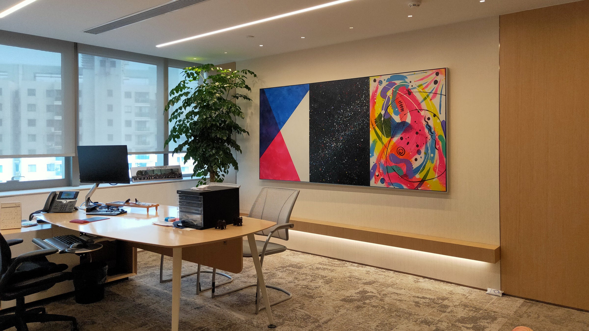 Three-panel work installed in an executive office